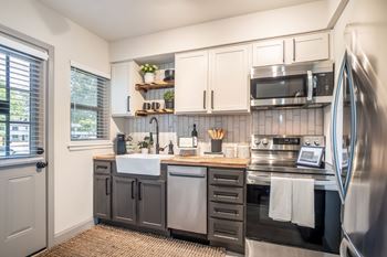A kitchen with a sink, stove, and refrigerator at Kiwi Goji Apartments, Tennessee, 38111